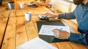 Male adviser filling in tax documents in office